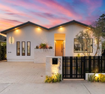 Modern,House,Exterior,With,Illuminated,Facade,And,Vibrant,Sunset,Sky,